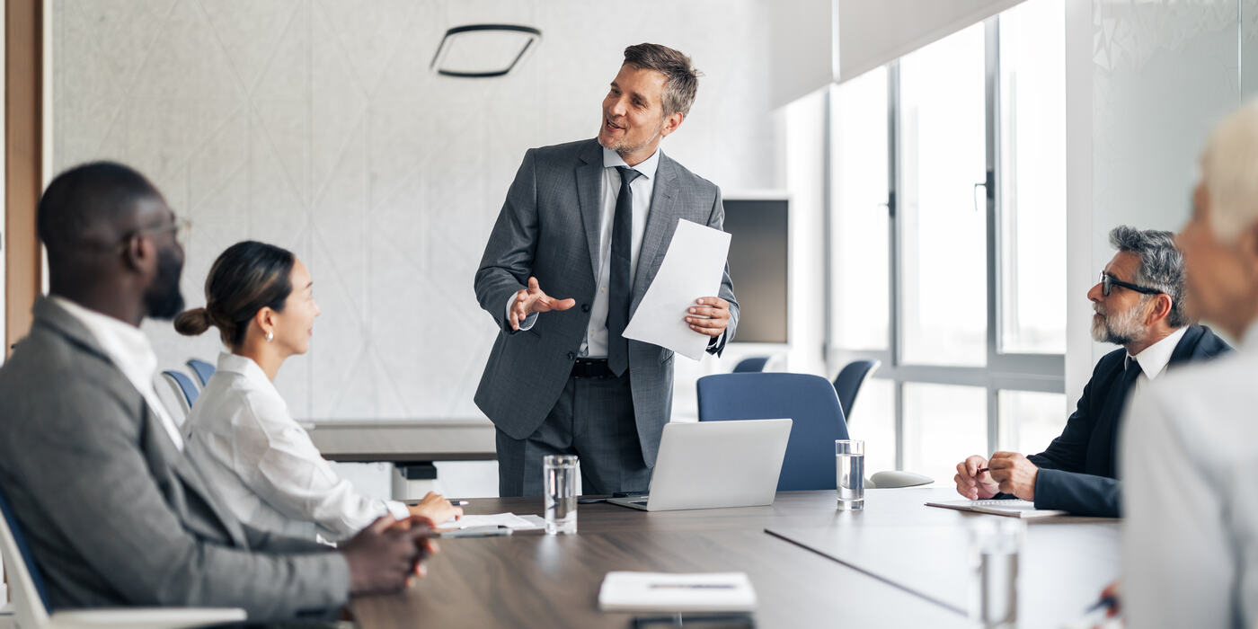 Executive presenting to a board in a meeting room